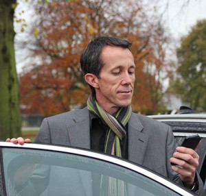 Man looking at Xero app on iphone in car